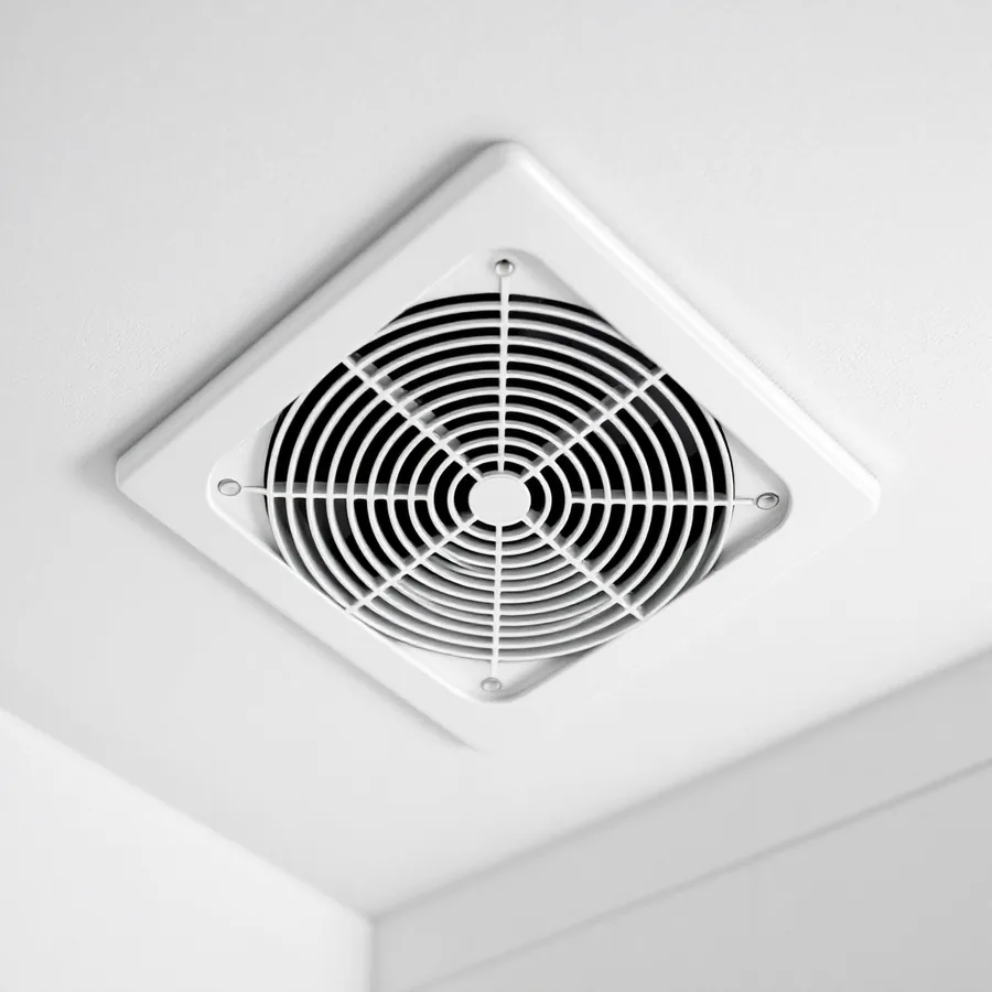 White ceiling bathroom exhaust fan grille set into a painted ceiling